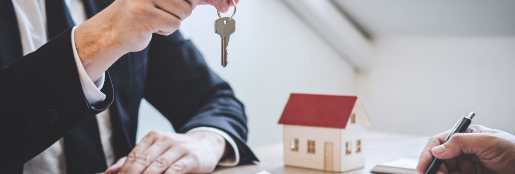 Estate agent passing over house keys