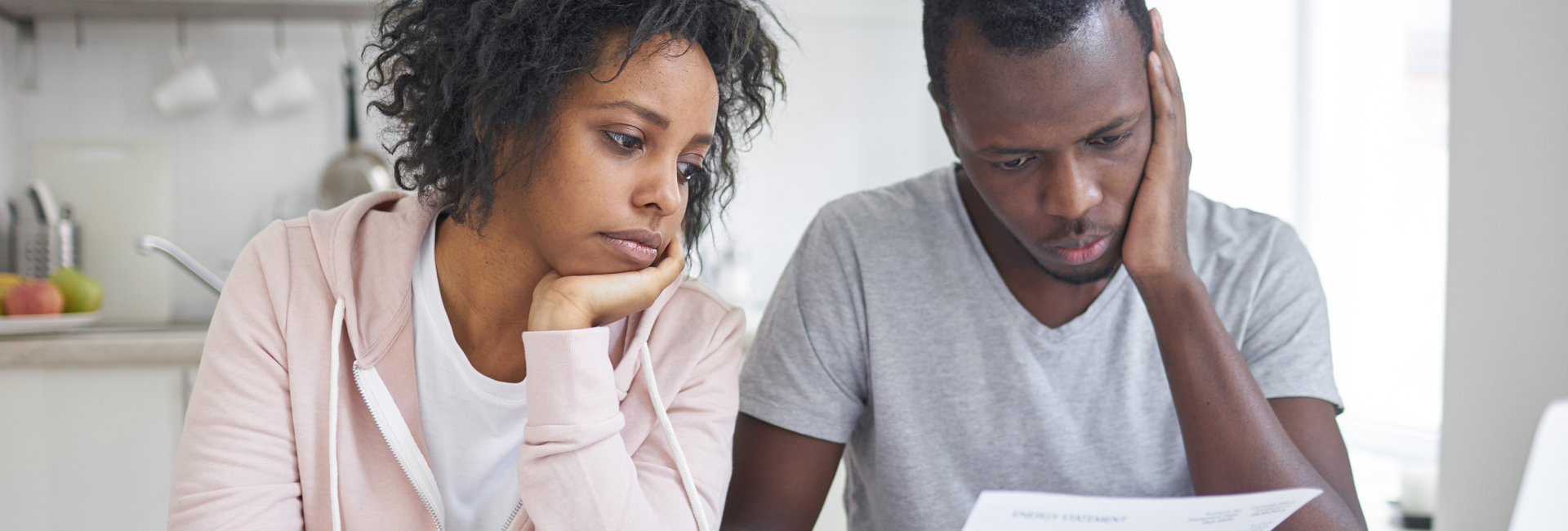 Worried couple looking at financial paperwork